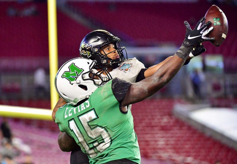 Tay Gowan #23 of the UCF Knights breaks up a pass intended for Armani Levias #15 of the Marshall Thundering Herd during the fourth quarter at the Bad Boy Mowers Gasparilla Bowl at Raymond James Stadium on December 23, 2019 in Tampa, Florida