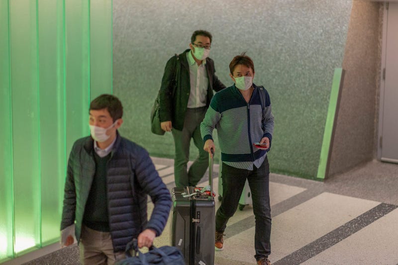 Travelers arrive to LAX Tom Bradley International Terminal wearing medical masks for protection against the novel coronavirus outbreak on February 2, 2020 in Los Angeles.