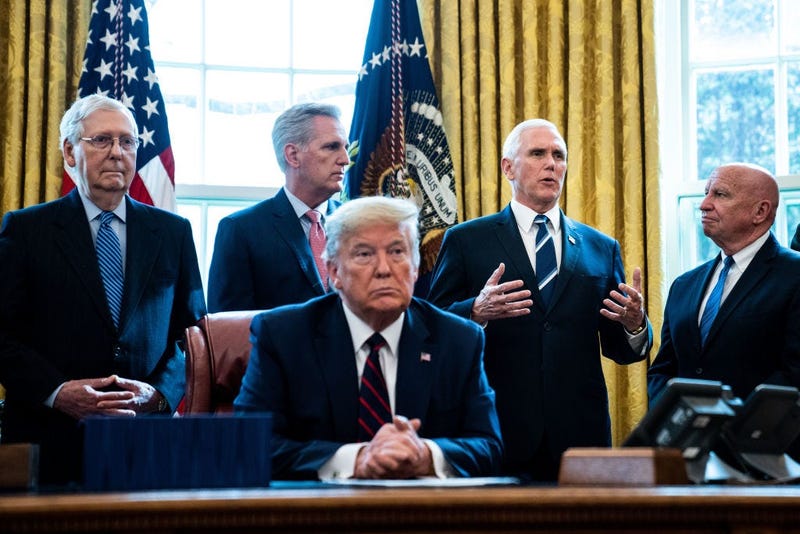 Vice President Mike Pence speaks as U.S. President Donald Trump listens during a bill signing ceremony for H.R. 748, the CARES Act