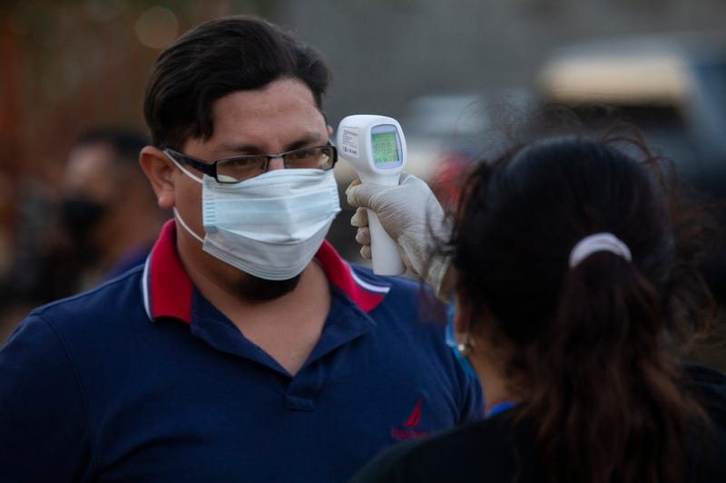 A man's temperature is measured prior the final match between Managua FC and Real Estelí as part of Nicaraguan Liga Primera at Estadio Nacional on May 9, 2020 in Managua, Nicaragua.