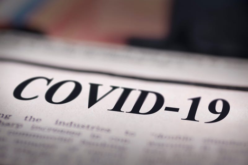 COVID-19 written newspaper close up shot to the text