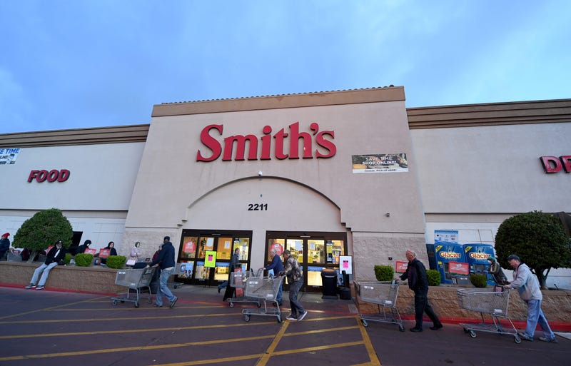 Shoppers get carts as they line up before a Smith's Food & Drug store opens on March 20, 2020 in Las Vegas, Nevada.