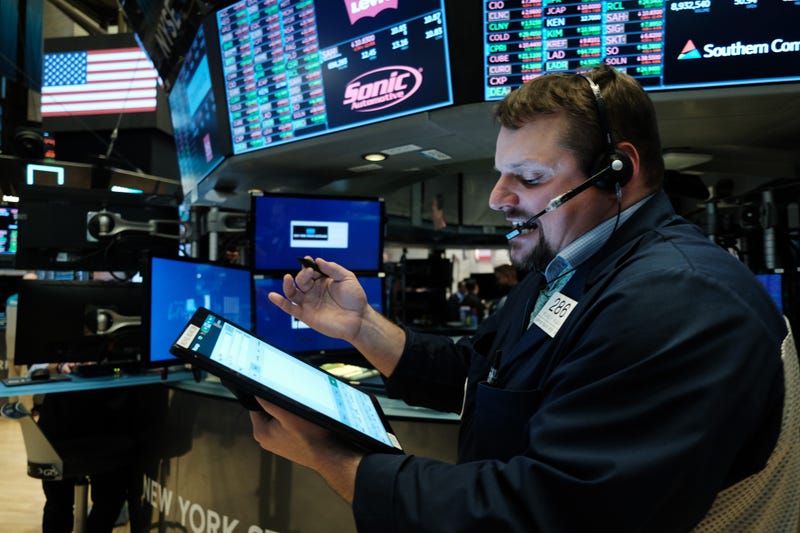 Traders work on the floor of the New York Stock Exchange (NYSE) on March 20, 2020 in New York City. 