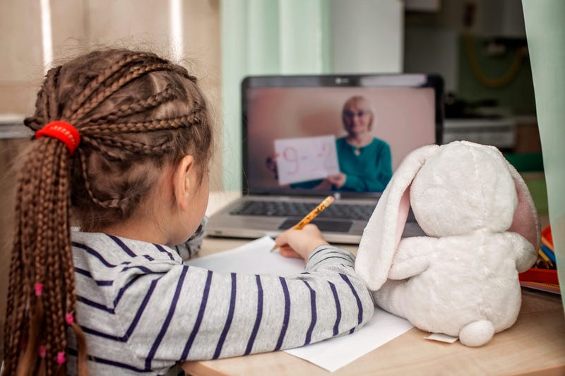 schoolgirl studying math during her online lesson at home, social distance during quarantine, self-isolation, online education concept