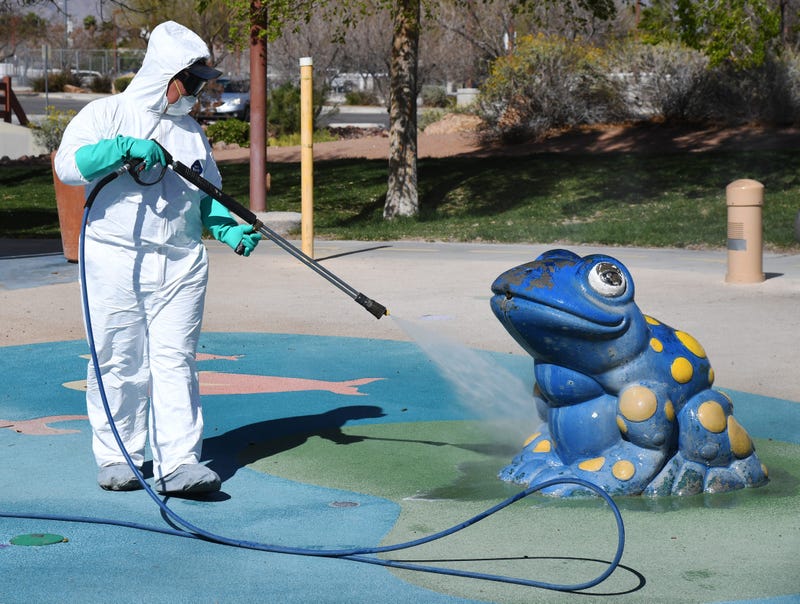 City of Las Vegas operations and maintenance staff worker Denis Connelly pressure washes playground equipment at Centennial Hills Park as part of an effort to keep the city's 70 parks open for the public during the coronavirus pandemic on March 25, 2020 i
