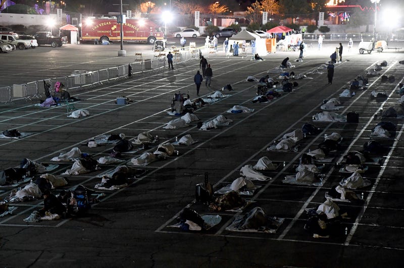 People are shown in social-distancing boxes at a temporary homeless shelter set up in a parking lot at Cashman Center on March 30, 2020 in Las Vegas, Nevada