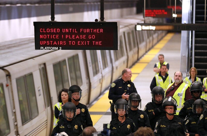 Bay Area Rapid Transit (BART) police officers stand on the platform at the Civic Center station after the station was closed due to a protest on August 22, 2011 in San Francisco, California.