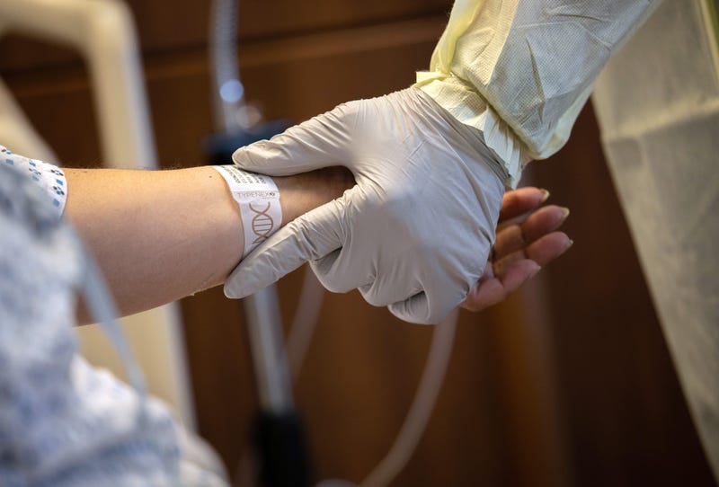 A hospital worker prepares COVID-19 patient and Guatemalan asylum seeker Zully to take her first steps after being removed from a ventilator at a Stamford Hospital ICU on April 24, 2020 in Stamford, Connecticut. 