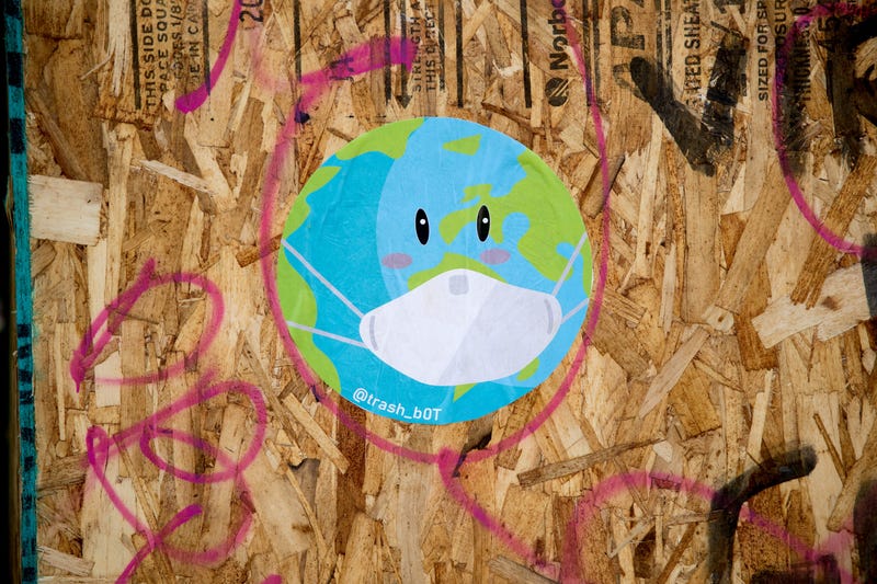 A recently painted mural of a world and a mask is displayed on a board during the coronavirus pandemic on May 03, 2020 in San Francisco, California.