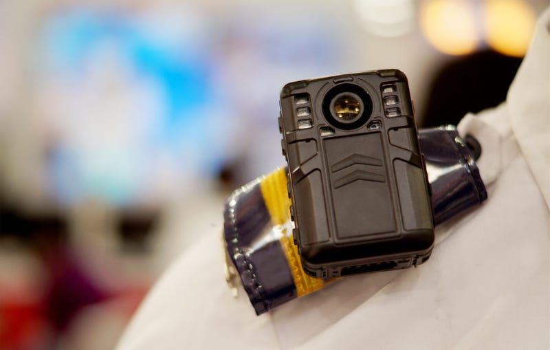 Police body camera on uniformed officer's shoulder