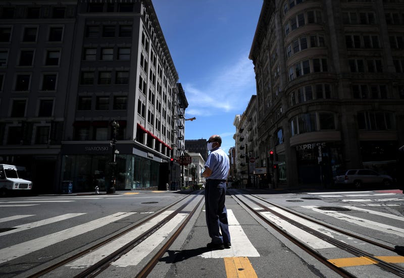 SAN FRANCISCO, CALIFORNIA - MAY 15: A U.S. Postal Service letter carrier stands in the middle of Powell Street on May 15, 2020 in San Francisco, California.