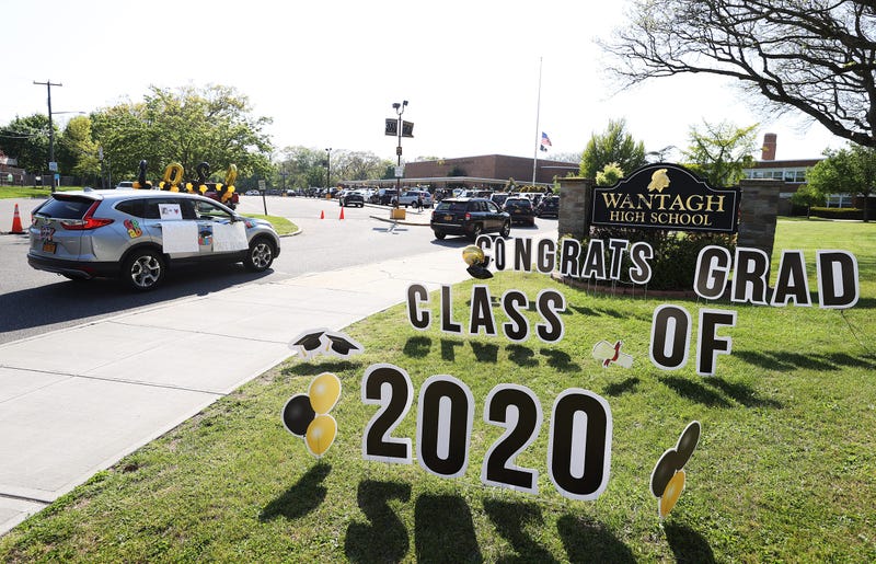 Graduating Seniors from Wantagh High School drive by the front of the school in a Class of 2020 Parade on May 15, 2020 in Wantagh, New York.