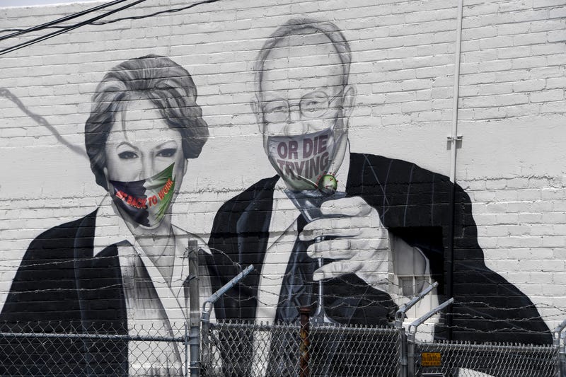 A mural on the side of the Majestic Repertory Theater depicts Las Vegas Mayor Carolyn Goodman (L) and her husband, former Las Vegas Mayor Oscar Goodman, with masks added over their faces in the downtown Arts District amid the spread of the coronavirus on 