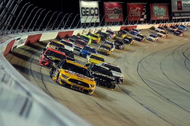 A NASCAR race and a graduation parade on a Wednesday