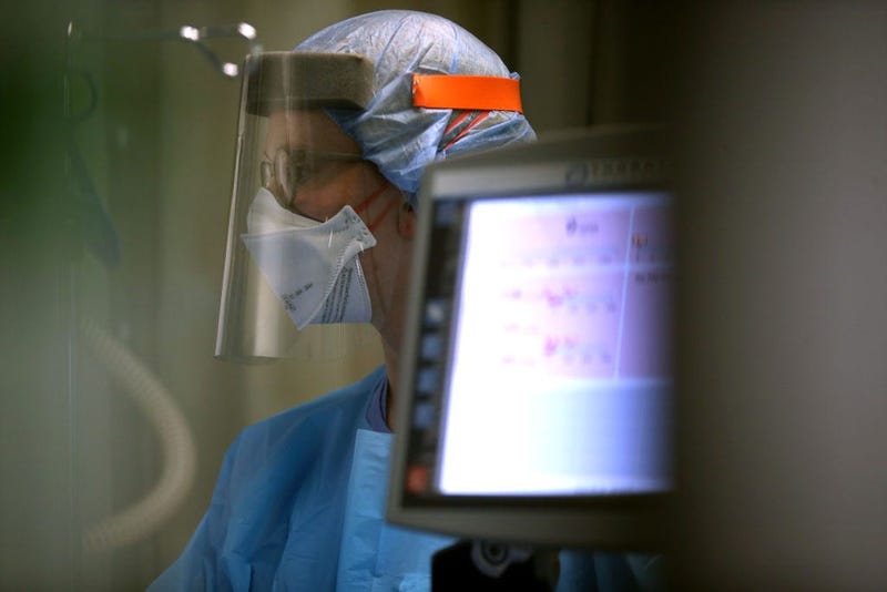 A nurse wears personal protective equipment (PPE)