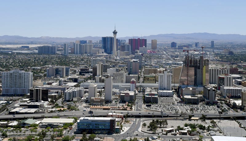 An aerial view shows hotel-casinos and other venues downtown (foreground) and on the Las Vegas Strip