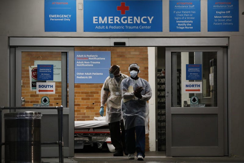 Medical workers walk outside a special coronavirus area at Maimonides Medical Center on May 26, 2020 in the Borough Park neighborhood of the Brooklyn borough of New York City.