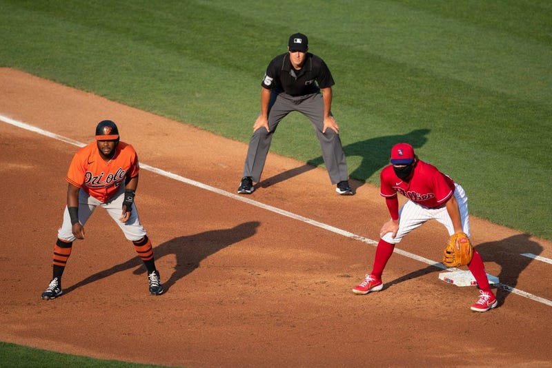 Hanser Alberto #57 of the Baltimore Orioles leads off first base against Rhys Hoskins #17 of the Philadelphia Phillies 