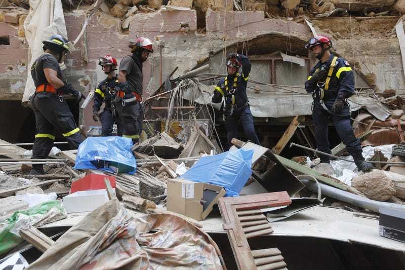 Emergency workers search a collapsed building on August 6, 2020 in Beirut, Lebanon.