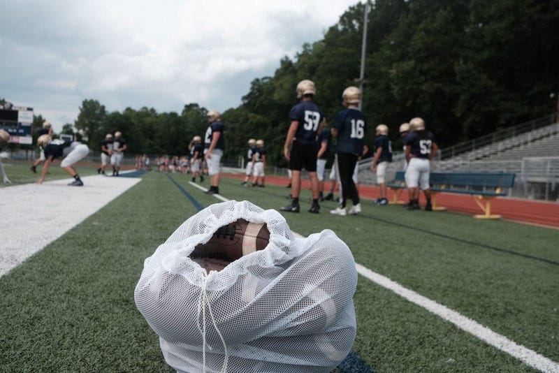 LANCASTER, OH - AUGUST 18: Football players from Lancaster High School line up to start running drills during football practice on August 18, 2020 in Lancaster, Ohio. Due to the continuing coronavirus (COVID-19) pandemic, many schools continue to hold pra
