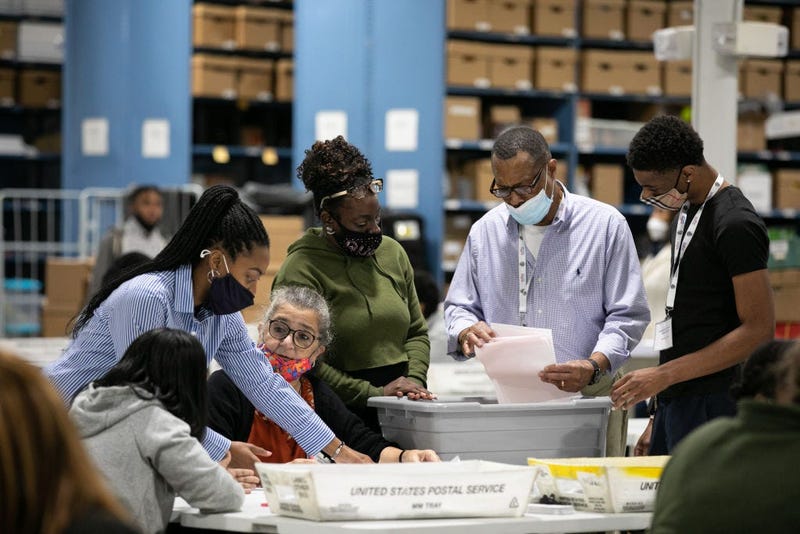 Gwinnett County election workers look over absentee and provisional ballots at the Gwinnett Voter Registrations and Elections office on November 6, 2020 in Lawrenceville, Georgia.