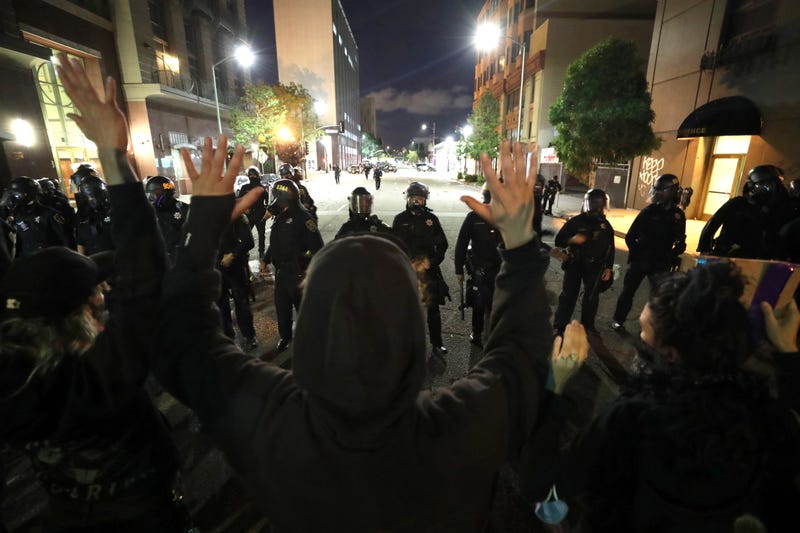 OAKLAND, CALIFORNIA - MAY 29: Demonstrators hold up their arms during a protest sparked by the death of George Floyd while in police custody on May 29, 2020 in Oakland, California.