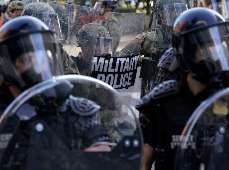Law enforcement officers and members of the National Guard monitor a protest on June 1, 2020 in downtown Washington, DC.