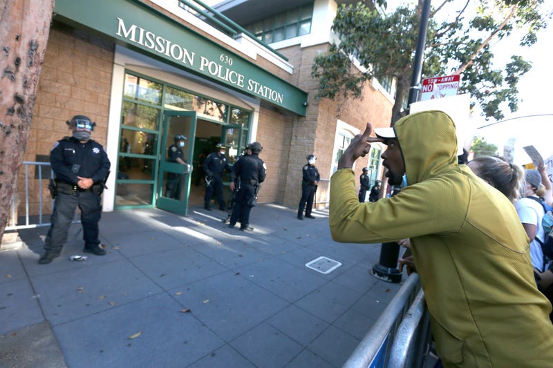 SAN FRANCISCO, CALIFORNIA - JUNE 03: A protester gestures towards San Francisco police officers during a demonstration to honor of George Floyd on June 03, 2020 in San Francisco, California.