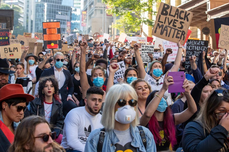 BRISBANE, AUSTRALIA - JUNE 06: People kneel in the CBD on June 06, 2020 in Brisbane, Australia.