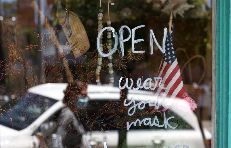 A pedestrian walks by a retail store that has reopened on June 16, 2020 in San Francisco, California.