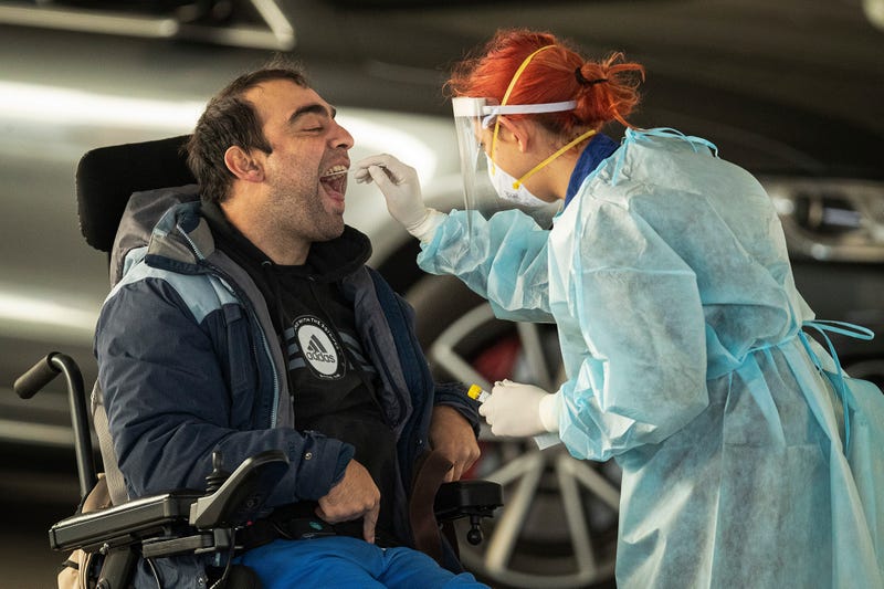 A disabled man is given a COVID-19 test at a drive-in pop-up site in Broadmeadows on July 01, 2020 in Melbourne, Australia.