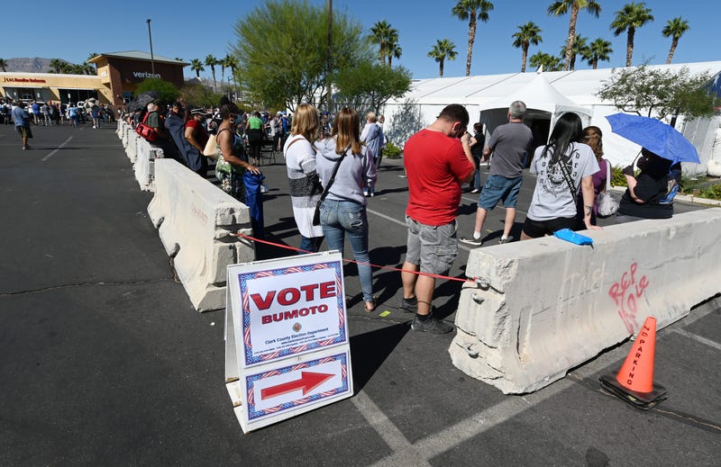People line up to vote at a shopping center on the first day of in-person early voting on October 17, 2020 in Las Vegas, Nevada. Early voting for the general election in the battleground state continues through October 30.