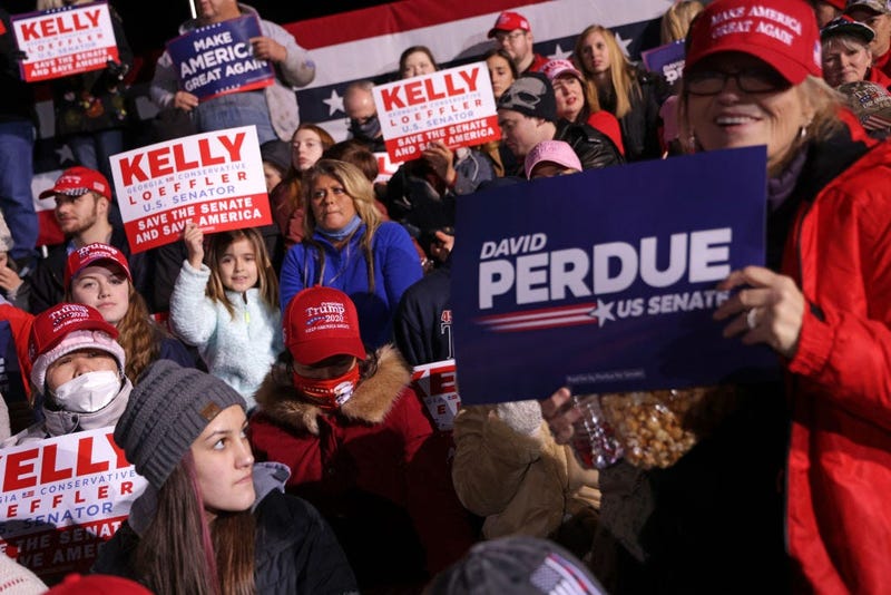 Supporters participate in a Republican National Committee Victory Rally at Dalton Regional Airport January 4, 2021 in Dalton, Georgia. President Trump campaigned for the two incumbents, Sen. David Perdue (R-GA) and Sen. Kelly Loeffler (R-GA).