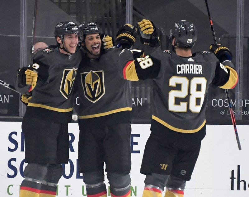 Tomas Nosek #92, Ryan Reaves #75 and William Carrier #28 of the Vegas Golden Knights celebrate after Reaves assisted Nosek on a first-period goal against the Anaheim Ducks at T-Mobile Arena on January 14, 2021 in Las Vegas, Nevada.
