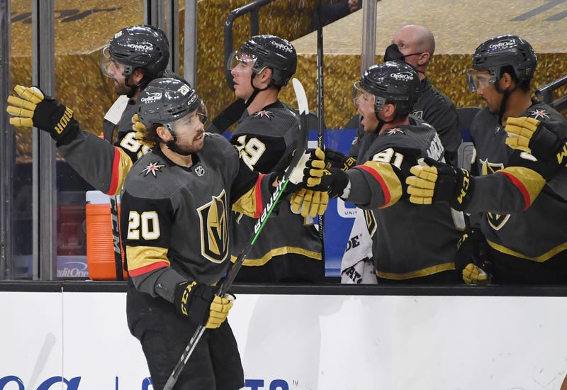  Chandler Stephenson #20 of the Vegas Golden Knights celebrates with teammates on the bench after scoring a third-period goal against the Arizona Coyotes during their game at T-Mobile Arena on January 18, 2021 in Las Vegas, Nevada. The Golden Knights defe