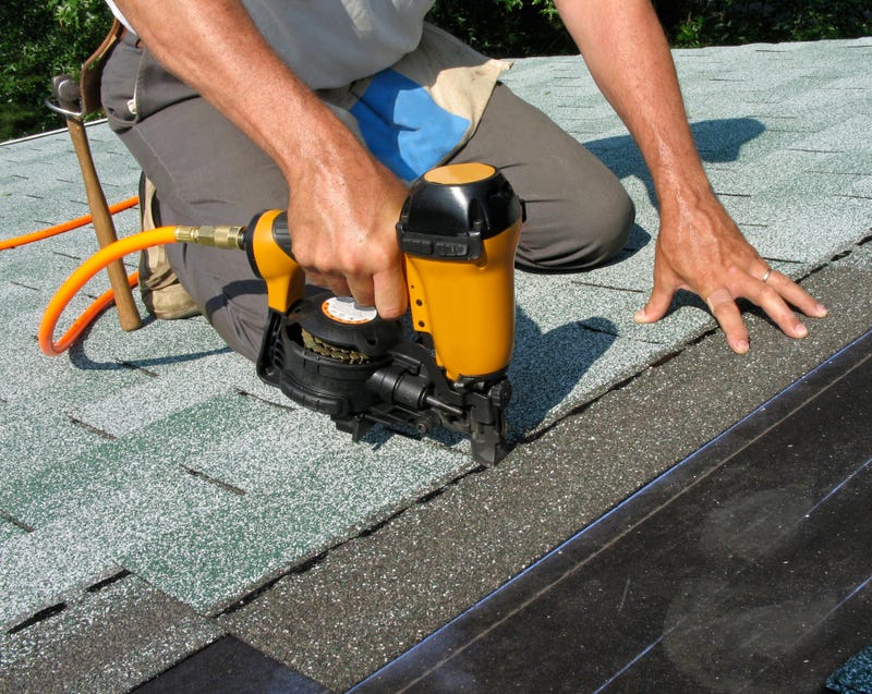 Man using nail gun - stock photo