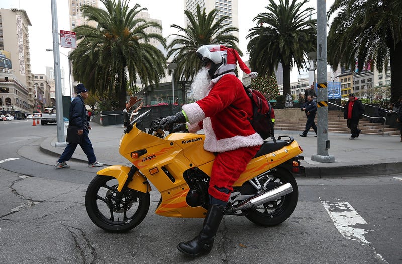  A man dressed as Santa Claus rides a motorcycle in Union Square on December 14, 2012 in San Francisco.