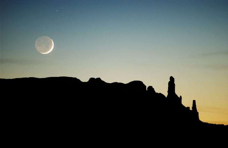 NAVAJO INDIAN RESERVATION, AZ - DECEMBER 5: The moon sets over sandstone formations near Round Rock December 5, 2002 on the Navajo Indian Reservation, Arizona.