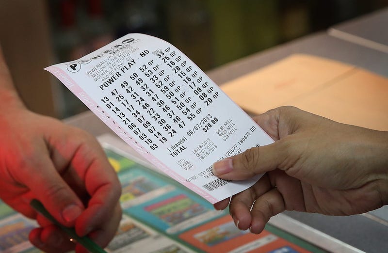 A customer purchases a Powerball lottery ticket at a 7-Eleven store on August 7, 2013 in Chicago, Illinois.