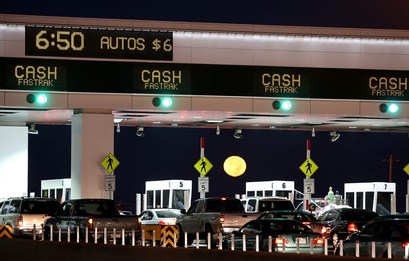  The moon sets as traffic backs up at the San Francisco-Oakland Bay Bridge toll plaza while commuters make their way into San Francisco on the first day of the (Bay Area Rapid Transit) BART strike on October 18, 2013 in Oakland, California.