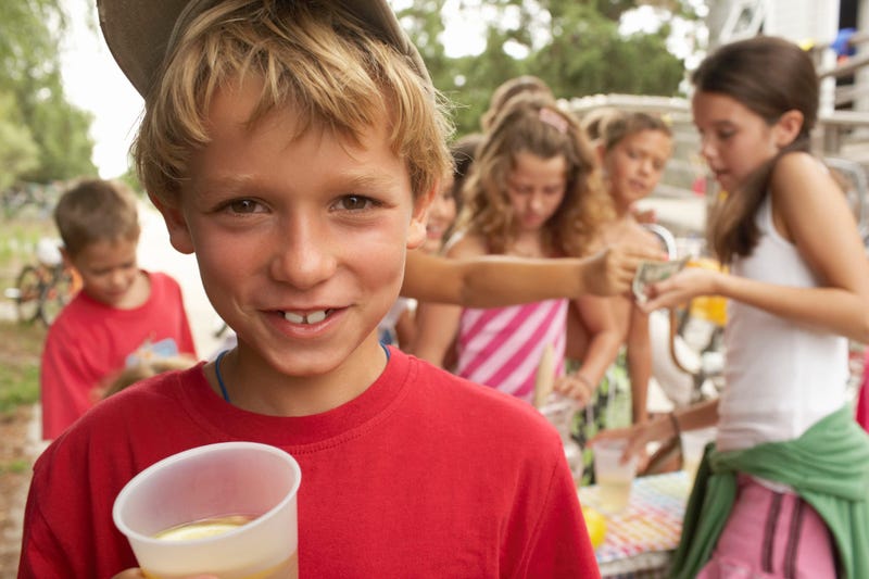 Children selling drinks at a homemade stand