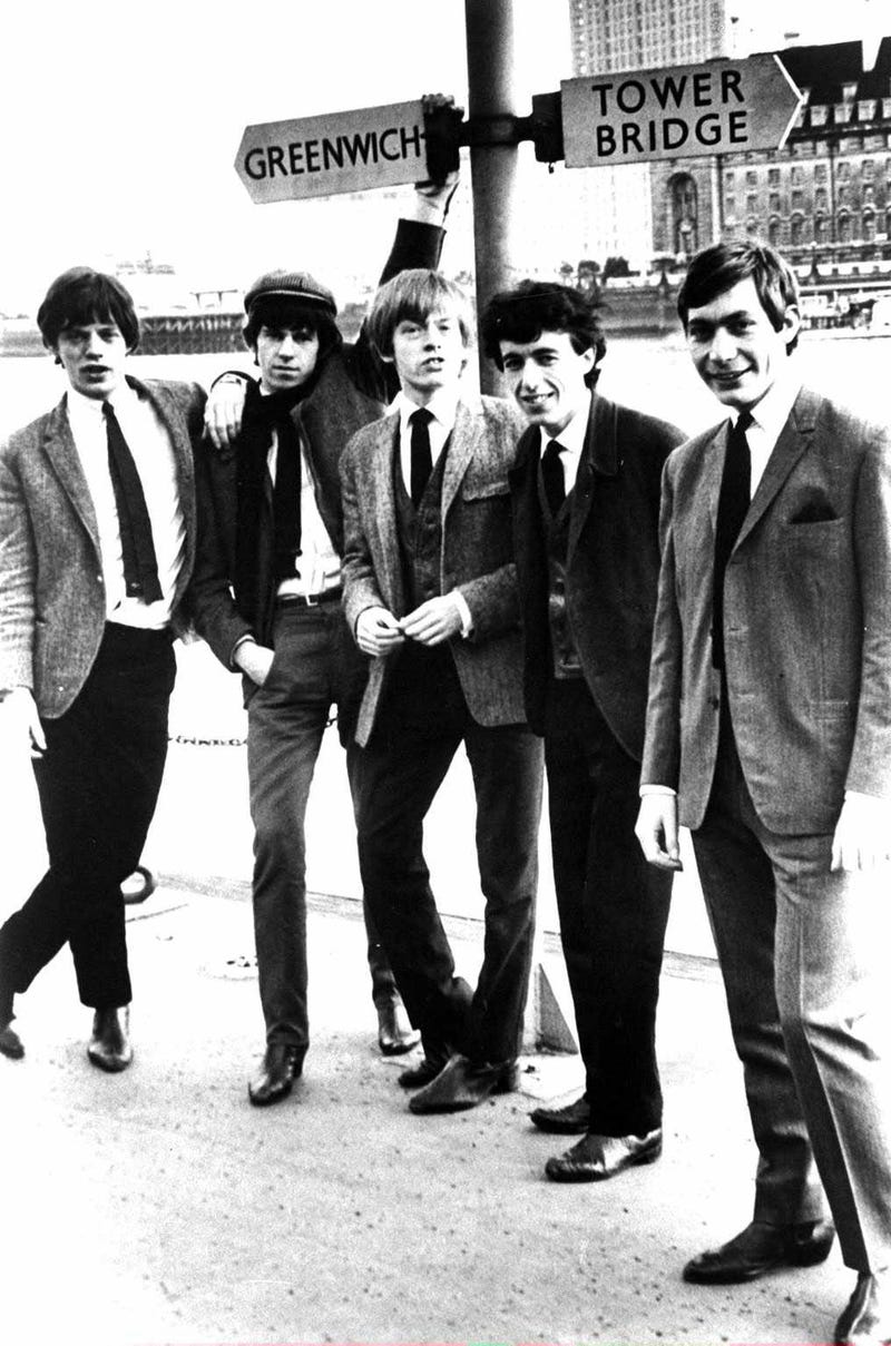 The Rolling Stones poses beneath a sign for Greenwich and Tower Bridge Streets in London, England, circa 1963. L-R: Mick Jagger, Keith Richards, Brian Jones (1942 - 1969), Bill Wyman and Charlie Watts. 
