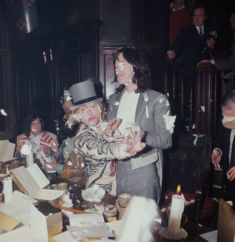 Brian Jones (1942 - 1969) and Mick Jagger of the British rock group The Rolling Stones, enjoying a food fight at the Kensington Gore Hotel, where the band staged a mock-medieval banquet for the launch of their new album 'Beggars Banquet', while the band's