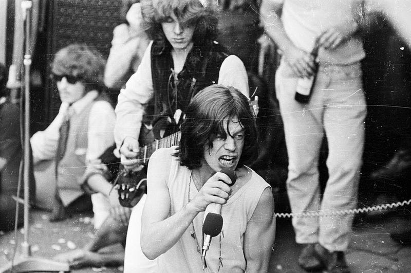 Mick Jagger and guitarist Mick Taylor in concert with the Rolling Stones in London's Hyde Park. The free outdoor concert was a tribute to recently deceased band member Brian Jones. 
