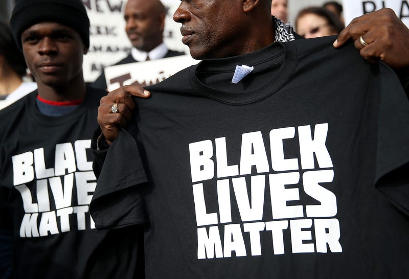 SAN FRANCISCO, CA - DECEMBER 18: A protester holds a black lives matter t-shirt during a "Hands Up, Don't Shoot" demonstration in front of the San Francisco Hall of Justice on December 18, 2014 in San Francisco, California.