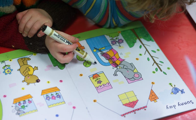ADSTOCK, UNITED KINGDOM - JANUARY 06: A young girl draws at a playgroup for pre-school aged children in Chilcompton near Radstock on January 6, 2015 in Somerset, England.
