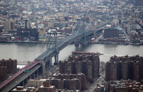 The Williamsburg Bridge spans the East River from Manhattan towards Brooklyn