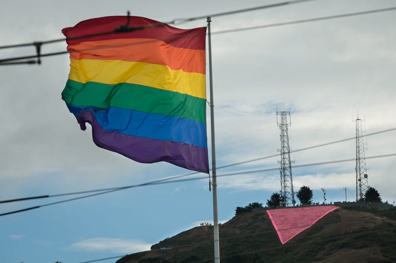 A large pink triangle is seen behind a rainbow flag during a gay pride celebration on June 27, 2015 in San Francisco, California.