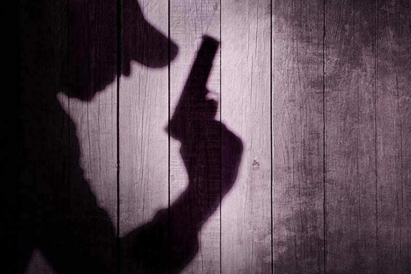 Shadow of a man holding a handgun