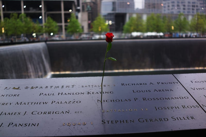 A rose is placed on a name engraved along the South reflecting pool at the Ground Zero memorial site during the dedication ceremony of the National September 11 Memorial Museum in New York May 15, 2014 in New York City.